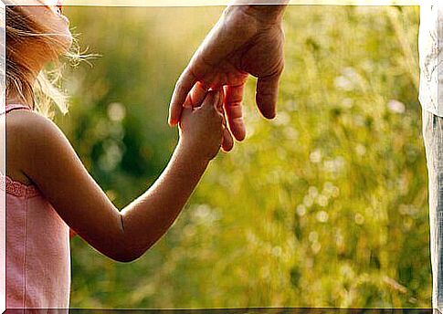 Father and daughter holding hands.