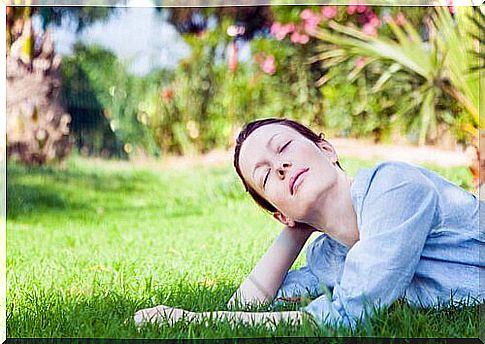 Woman lying on the grass and thinking about what she loves