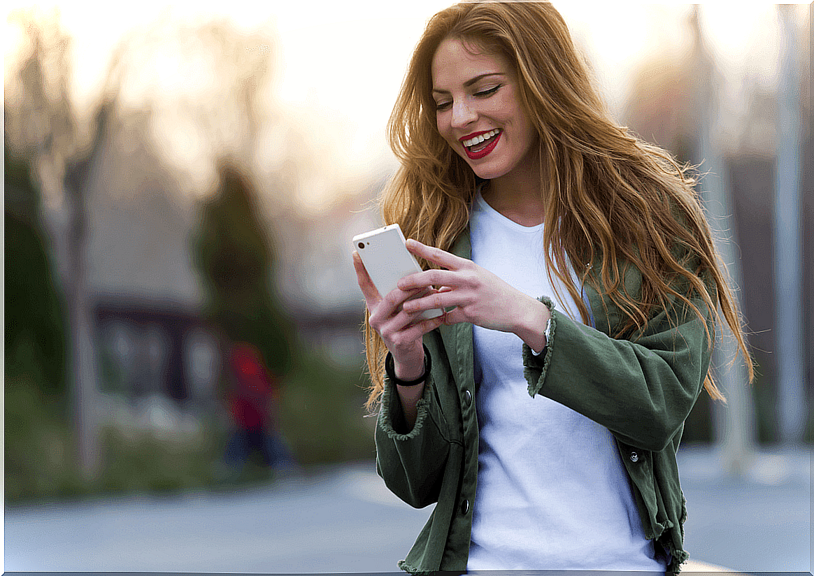 Woman surprised by birthday greetings on mobile