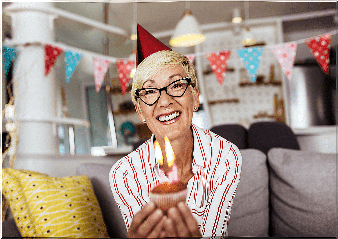 Senior woman celebrating birthday and receiving birthday greetings