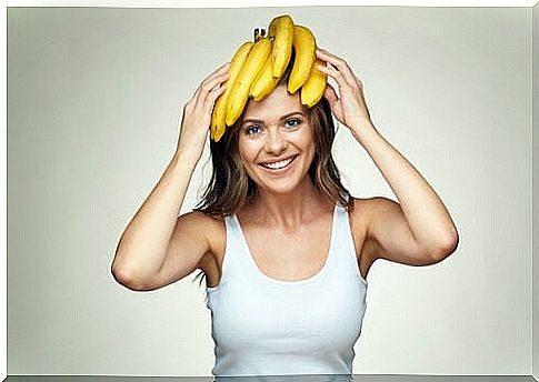 A woman with bananas on her head