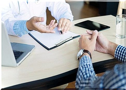 We see the arms and upper body of a doctor and a patient during a consultation