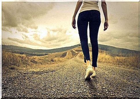 Woman walking along road