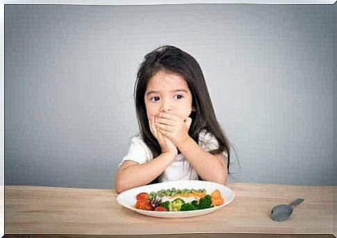 A child covering his mouth.