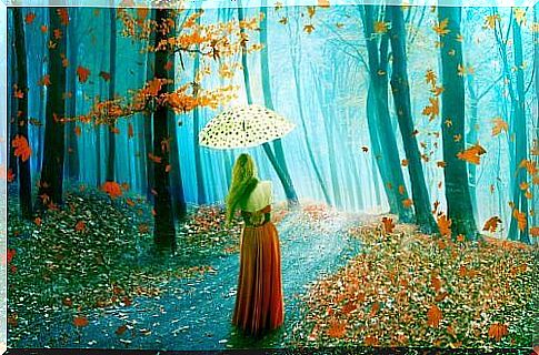 Girl with umbrella in autumn forest