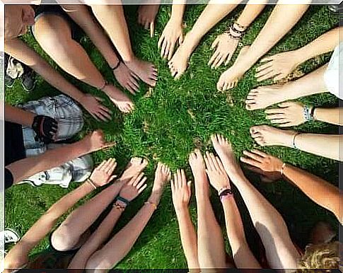 A circle made of human hands and feet.