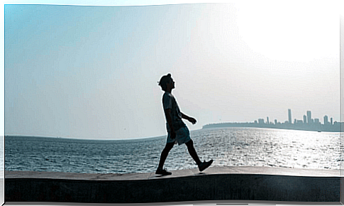 Man walking along the sea.