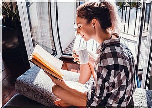 A woman reading at the door.