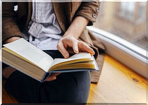 A person reading by the window.