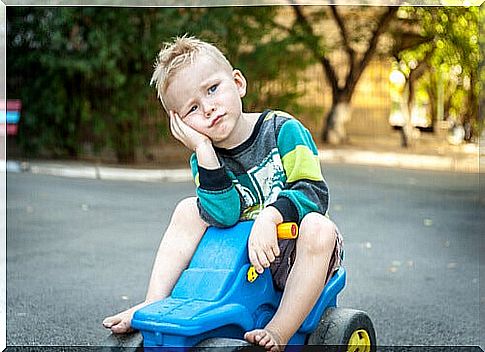 A little boy on a toy car