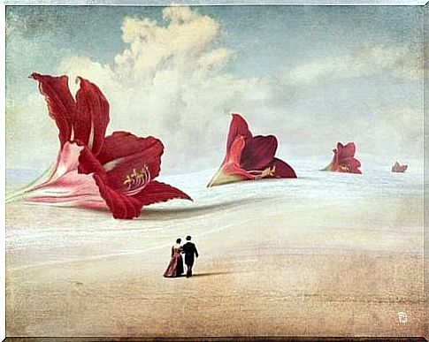 A couple walks along giant flowers