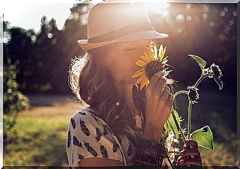 Woman smelling of flower