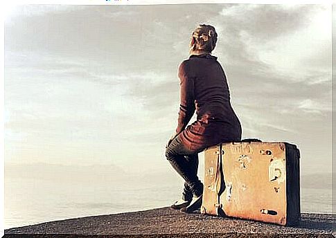 Woman sitting on a suitcase