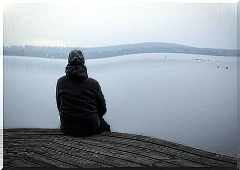 Person sitting on pier